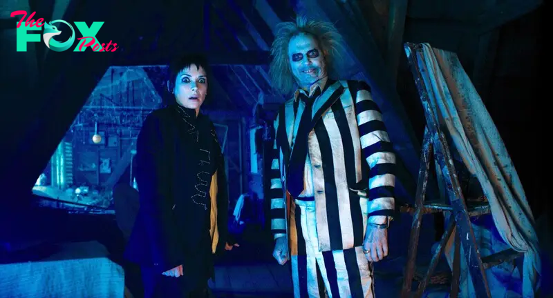 Lydia Deetz (Winona Ryder) and Betelgeuse (Michael Keaton) stand side by side in Beetlejuice Beetlejuice