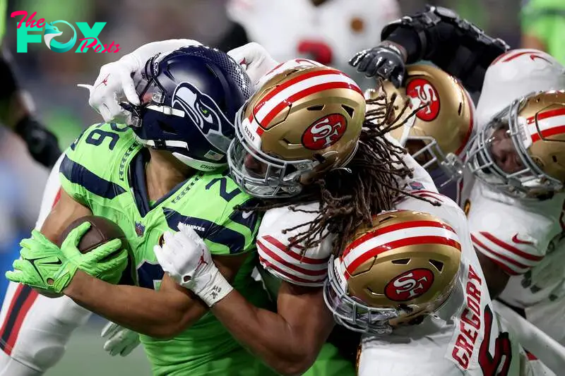 SEATTLE, WASHINGTON - NOVEMBER 23: Fred Warner #54 of the San Francisco 49ers tackles Zach Charbonnet #26 of the Seattle Seahawks during the second quarter at Lumen Field on November 23, 2023 in Seattle, Washington.   Steph Chambers/Getty Images/AFP (Photo by Steph Chambers / GETTY IMAGES NORTH AMERICA / Getty Images via AFP)