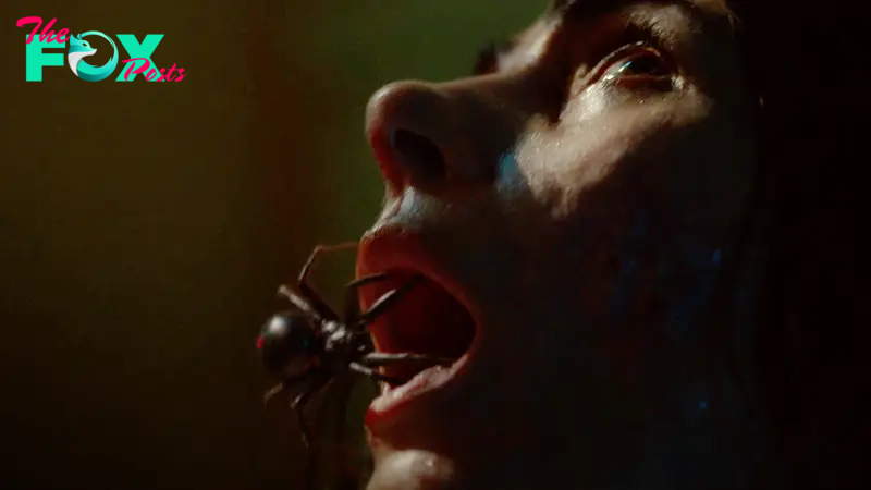 A spider crawling into the month of a woman with tears in her eyes in Sting (2024)