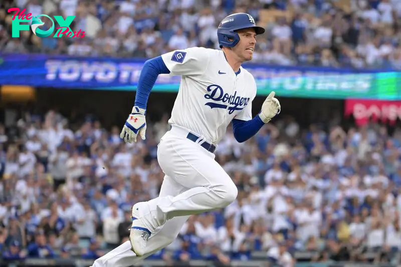 Oct 11, 2024; Los Angeles, California, USA; Los Angeles Dodgers first baseman Freddie Freeman (5) runs after hitting a single in the first inning during game five of the NLDS for the 2024 MLB Playoffs at Dodger Stadium. Mandatory Credit: Jayne Kamin-Oncea-Imagn Images