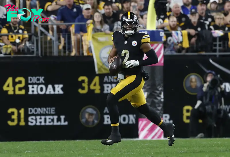 Oct 6, 2024; Pittsburgh, Pennsylvania, USA;  Pittsburgh Steelers quarterback Justin Fields (2) scrambles with the ball against the Dallas Cowboys during the first quarter at Acrisure Stadium. Mandatory Credit: Charles LeClaire-Imagn Images