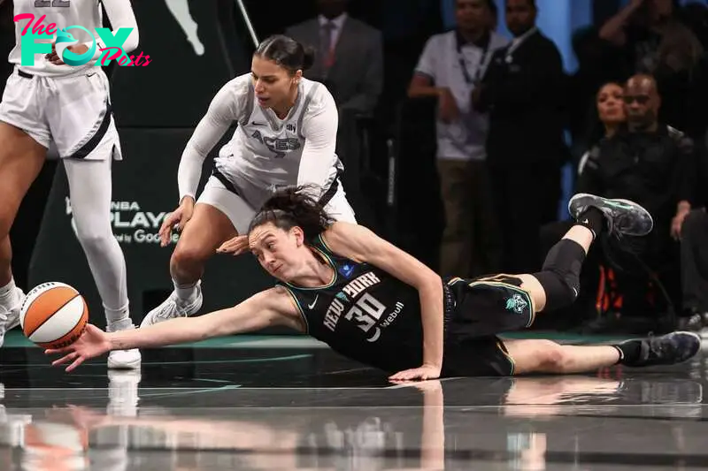 Oct 1, 2024; Brooklyn, New York, USA; New York Liberty forward Breanna Stewart (30) and Las Vegas Aces forward Alysha Clark (7) fight for a loose ball during game two of the 2024 WNBA Semi-finals at Barclays Center. Mandatory Credit: Wendell Cruz-Imagn Images