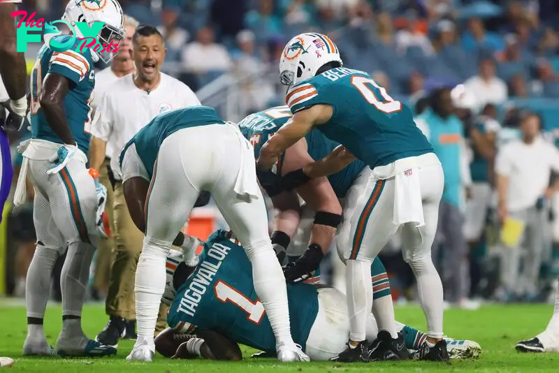  Miami Dolphins quarterback Tua Tagovailoa (1) is checked on by teammates after an apparent injury against the Buffalo Bills during the third quarter at Hard Rock Stadium. 