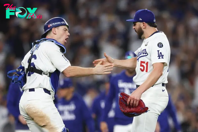 LOS ANGELES, CALIFORNIA - OCTOBER 26: Will Smith #16 and Alex Vesia #51 of the Los Angeles Dodgers celebrate their 4-2 win over the New York Yankees during Game Two of the 2024 World Series at Dodger Stadium on October 26, 2024 in Los Angeles, California.   Harry How/Getty Images/AFP (Photo by Harry How / GETTY IMAGES NORTH AMERICA / Getty Images via AFP)