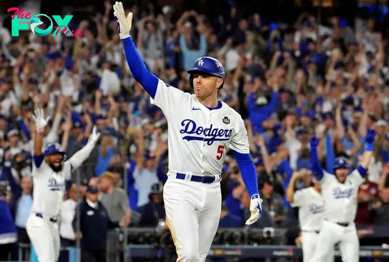 Oct 25, 2024; Los Angeles, California, USA; Los Angeles Dodgers first baseman Freddie Freeman (5) celebrates after hitting a grand slam home run in the tenth inning against the New York Yankees during game one of the 2024 MLB World Series at Dodger Stadium. Mandatory Credit: Jayne Kamin-Oncea-Imagn Images     TPX IMAGES OF THE DAY