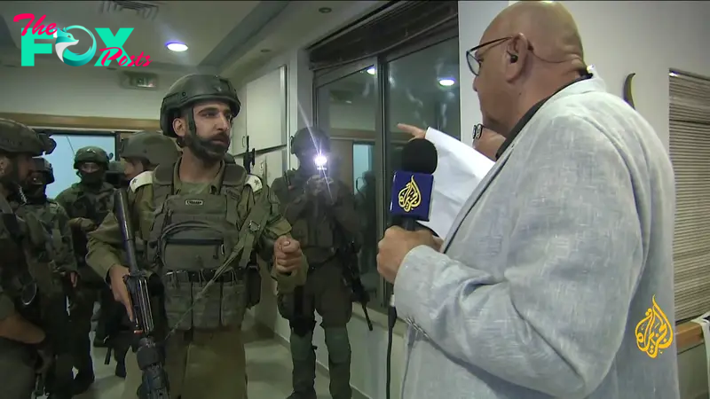 An image grab from footage distributed by the Al-Jazeera TV on Sept. 22, 2024 shows an Israeli soldier speaking with Walid Al-Omari, bureau chief of Al Jazeera in Jerusalem and Ramallah, upon entering Al Jazeera's office in Ramallah, in the West Bank to issue a 45-day closure order on September 21.