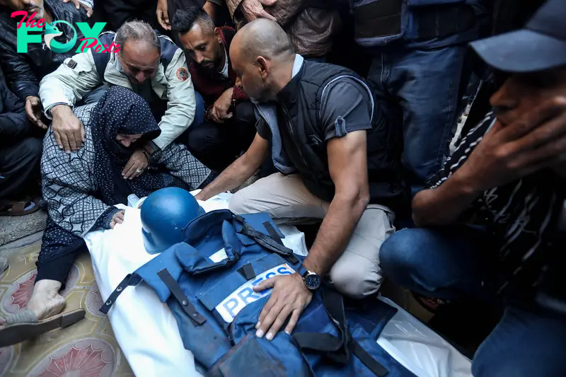 Relatives and friends bid farewell to the body of Al Jazeera cameraman Samer Abu Daqqa, who was killed while working in an air strike, in Khan Yunis, Gaza, on Dec. 16, 2023