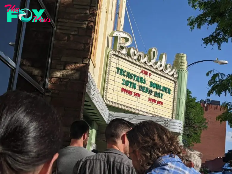 People standing in line outside the Boulder Theater, with the marquee advertising Techstars' last Demo Day in Boulder on June 6. The sign lists doors opening at 5 PM and the event starting at 5:30 PM.