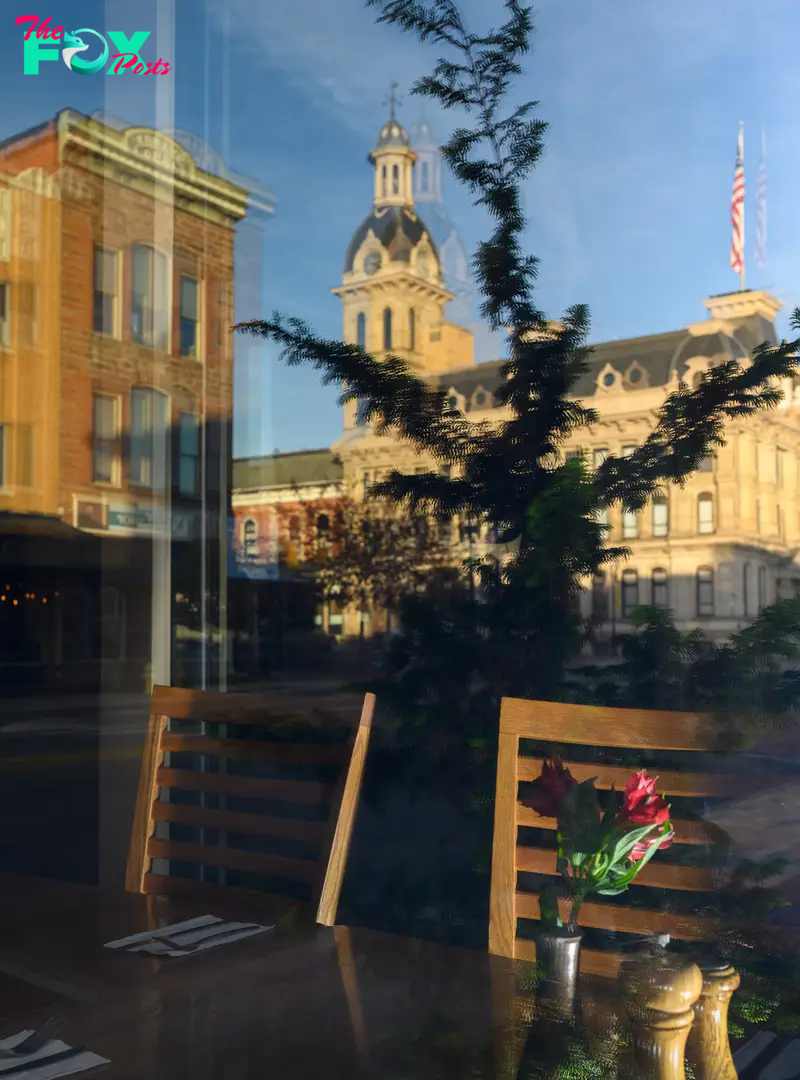 A reflection of the Wayne County Courthouse in the window of Broken Rocks Cafe and Bakery in Wooster, OH.