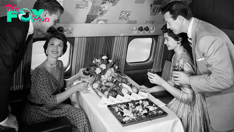 Travelers are served a buffet on board a Lockheed Super Constellation while flying with former American airline Trans World Airlines (TWA) in 1955