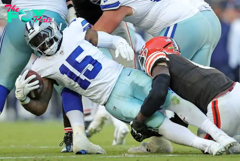 Dallas Cowboys running back Ezekiel Elliott (15) is wrapped up by Cleveland Browns linebacker Jeremiah Owusu-Koramoah (6) during the second half of an NFL football game at Huntington Bank Field, Sunday, Sept. 8, 2024, in Cleveland, Ohio.