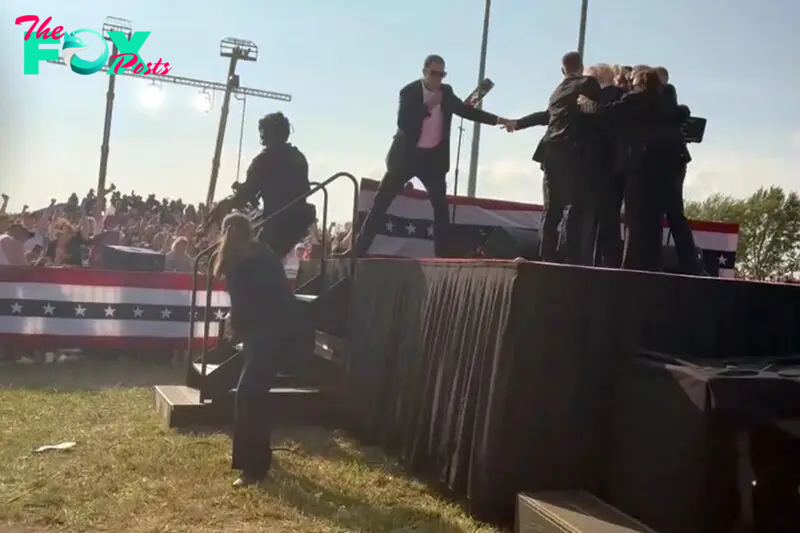 Trump was escorted off stage by a gaggle of Security Services agents, as rallygoers chant “USA!” and applaud.