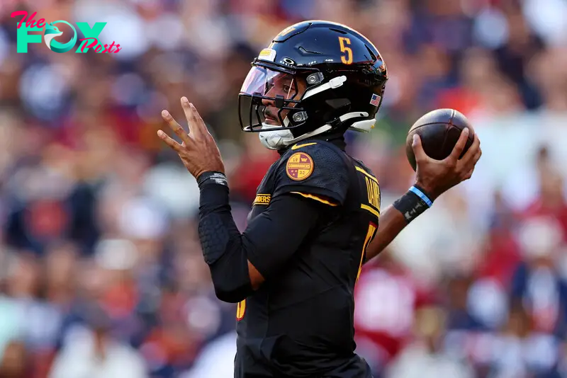 Oct 27, 2024; Landover, Maryland, USA; Washington Commanders quarterback Jayden Daniels (5) throws a pass during the first quarter against the Chicago Bears at Commanders Field. Mandatory Credit: Peter Casey-Imagn Images