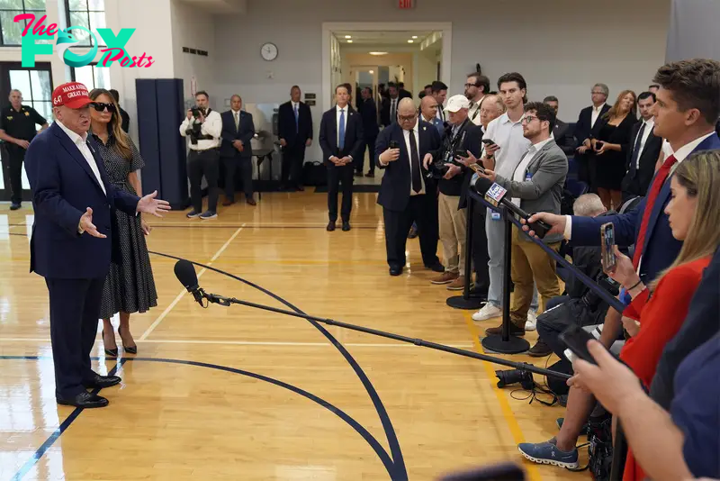 Republican presidential nominee former President Donald Trump speaks as former first lady Melania Trump listens after they voted on Election Day at the Morton and Barbara Mandel Recreation Center, in Palm Beach, Fla., Nov. 5, 2024.