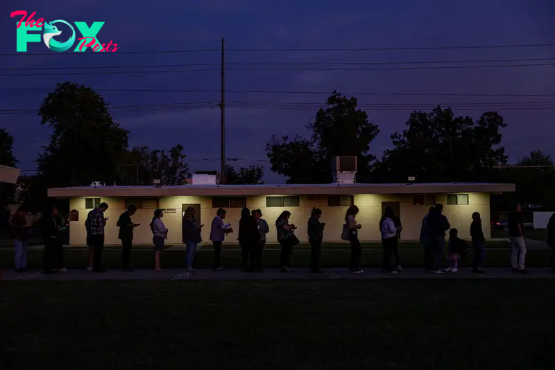 Voters wait in line at sunset to cast their ballots at a polling location inside a church in Phoenix, Ariz., on Election Day, Tuesday, Nov. 5, 2024. (Adriana Zehbrauskas/The New York Times)