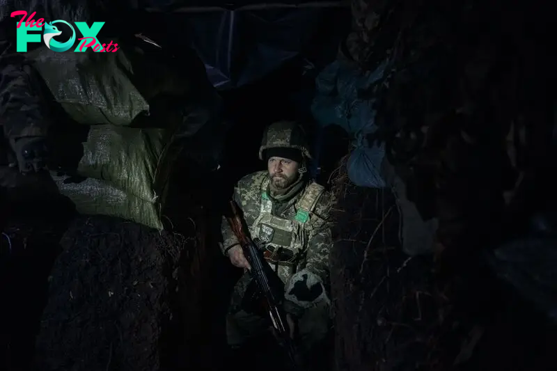 A Ukrainian soldier in a trench 100 meters from Russian positions in the Serebryansky forest of Ukraine on November 6, 2024.