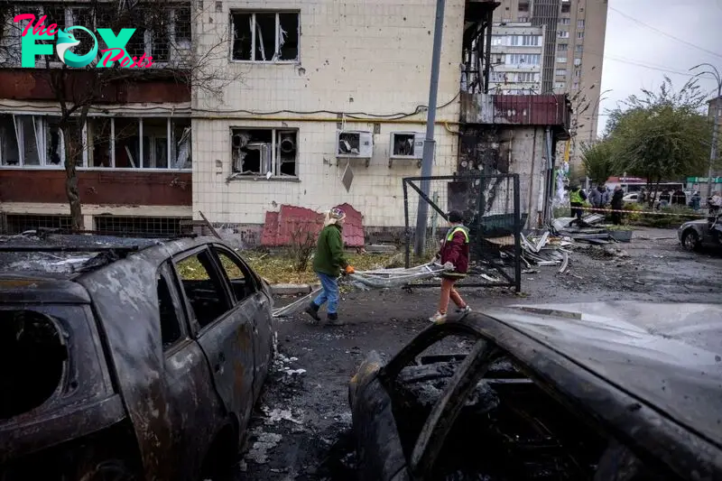 Workers remove debris from an apartment building that was damaged during a Russian drone strike in Kyiv, Ukraine, on October 29, 2024.