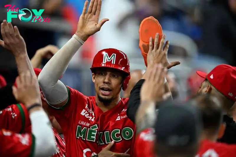 Mexico's outfielder #64 Aaron Altherr celebrates scoring a run during the Caribbean Series baseball game between Mexico and the Dominican Republic at LoanDepot Park in Miami, Florida, on February 4, 2024. (Photo by Chandan Khanna / AFP)