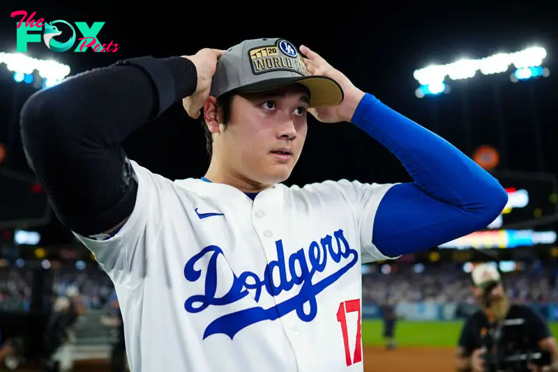 Shohei Ohtani #17 of the Los Angeles Dodgers puts a hat on to celebrate advancing to the World Series after winning Game 6 of the NLCS presented by loanDepot between the New York Mets and the Los Angeles Dodgers at Dodger Stadium in Los Angeles, Calif. on Oct. 20, 2024.