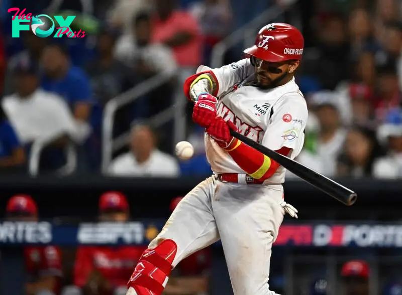 Panama's infielder #14 Johan Camargo takes a swing during the Caribbean Series baseball game between the Dominican Republic and Panama at LoanDepot Park in Miami, Florida, on February 7, 2024. (Photo by Chandan Khanna / AFP)