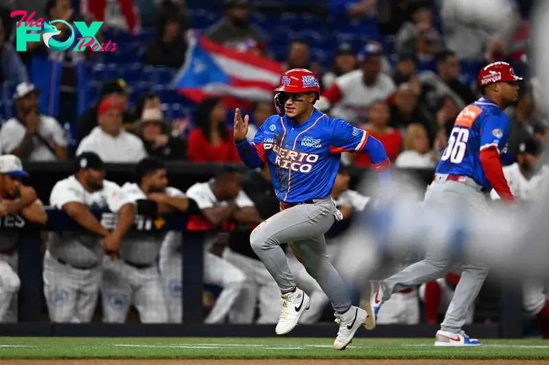 Puerto Rico's outfielder Bryan Torres runs to home base during the Caribbean Series baseball game between Panama and Puerto Rico at LoanDepot Park in Miami, Florida, on February 5, 2024. (Photo by Chandan Khanna / AFP)