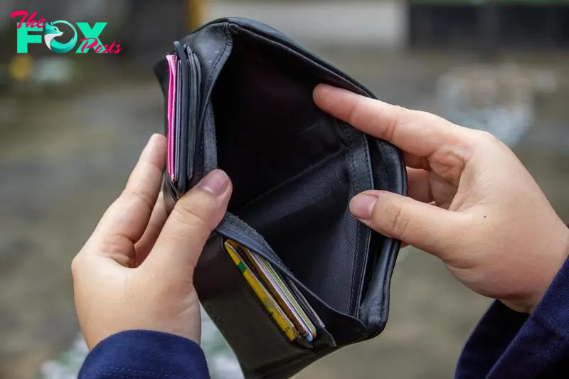 A person holding their empty wallet | Source: Pexels