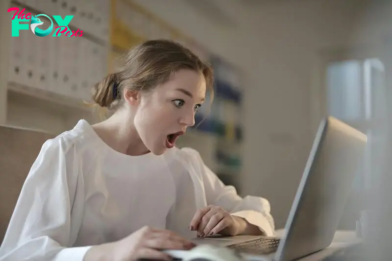 A shocked woman looking at something on her laptop | Source: Pexels