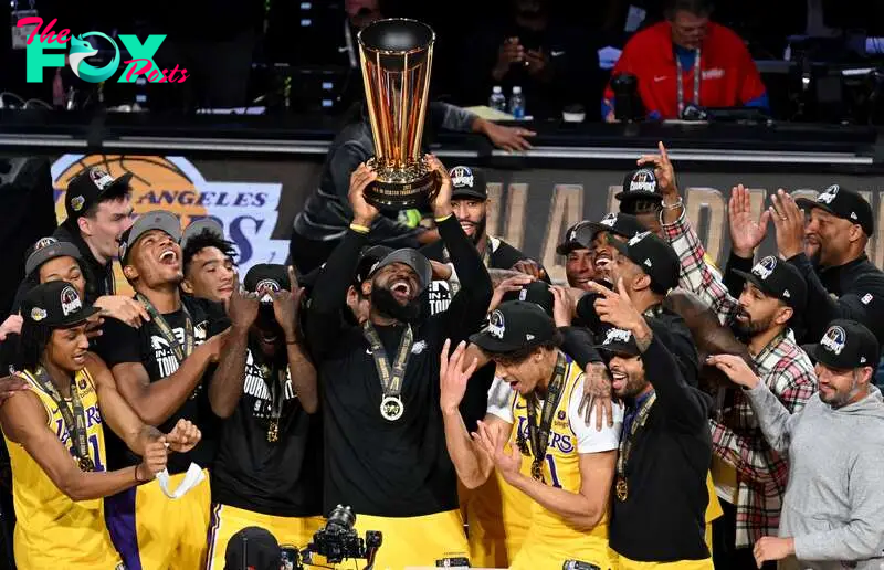 Dec 9, 2023; Las Vegas, Nevada, USA; Los Angeles Lakers forward LeBron James (23) hoists the NBA Cup and celebrates with teammates after winning the NBA In-Season Tournament Championship game against the Indiana Pacers at T-Mobile Arena. Mandatory Credit: Candice Ward-USA TODAY Sports