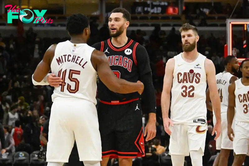 Chicago Bulls guard Zach LaVine (8) is hugged by Cleveland Cavaliers guard Donovan Mitchell (45)