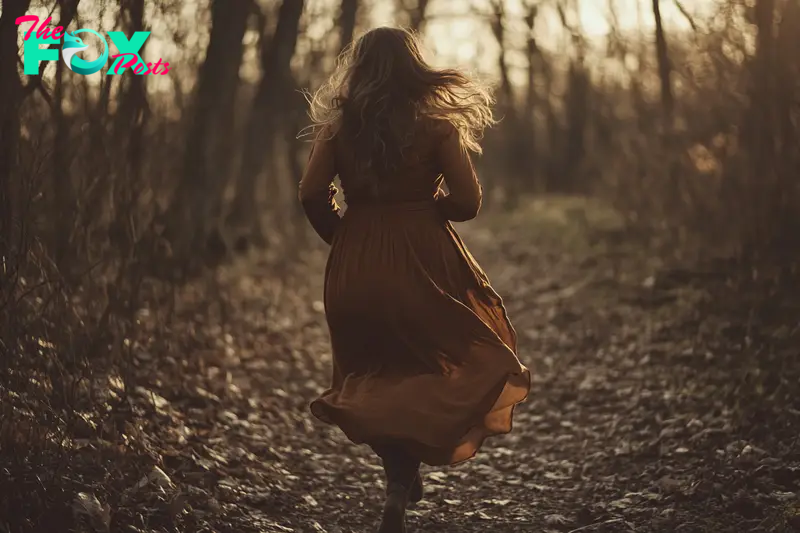 A woman running in the woods | Source: Midjourney