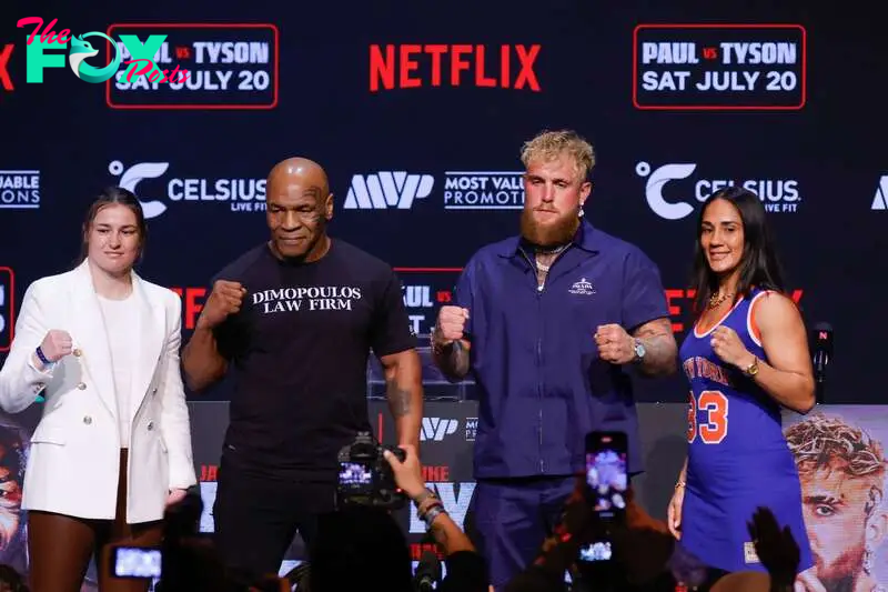 (From L) Irish boxer Katie Taylor, US former boxer Mike Tyson, YouTuber Jake Paul and Puerto Rican boxer Amanda Serrano pose at a press conference at the Apollo Theatre in New York, on May 13, 2024. Former heavyweight boxing champion Mike Tyson's July 20 fight against YouTube sensation Jake Paul in Dallas will be a sanctioned heavyweight professional bout, fighters and promoters announced on April 29. The fight will be over eight two-minute rounds with the result to count on the record of both Paul and Tyson, who lost his last official bout in 2005. (Photo by Kena Betancur / AFP)