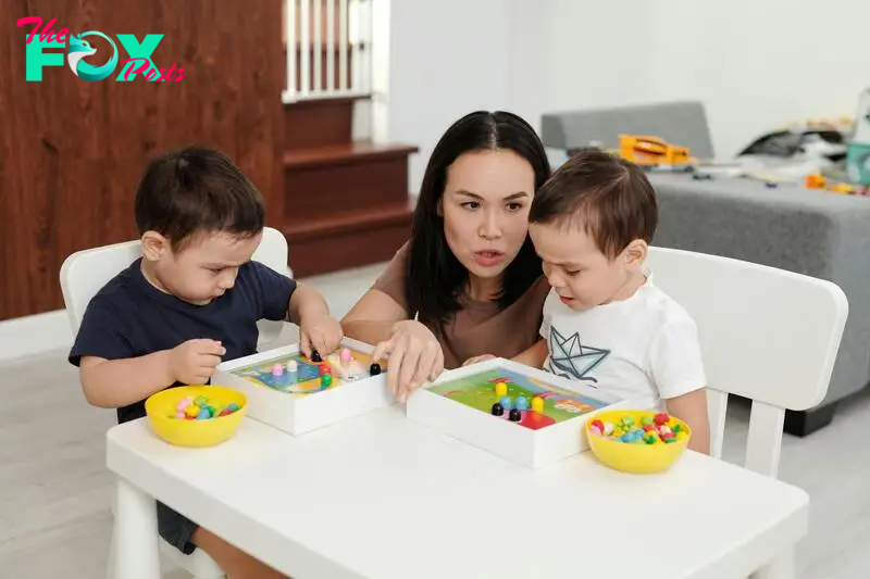 A woman playing with her children | Source: Pexels