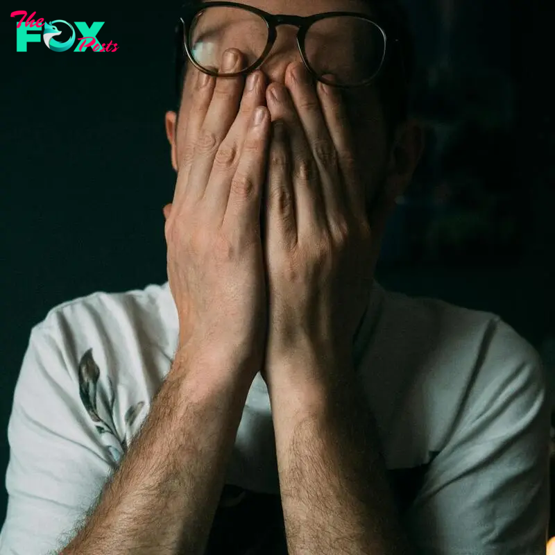 A startled man covering his face | Source: Pexels