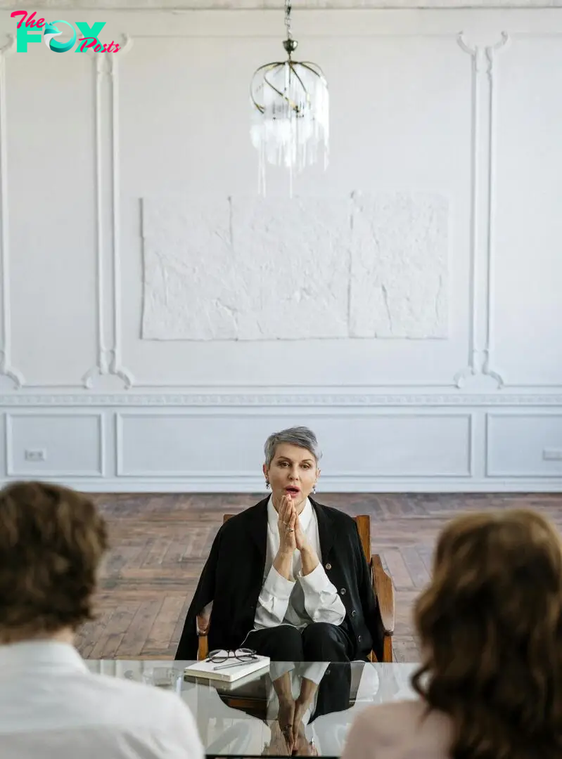 An older woman talking to a young couple | Source: Pexels