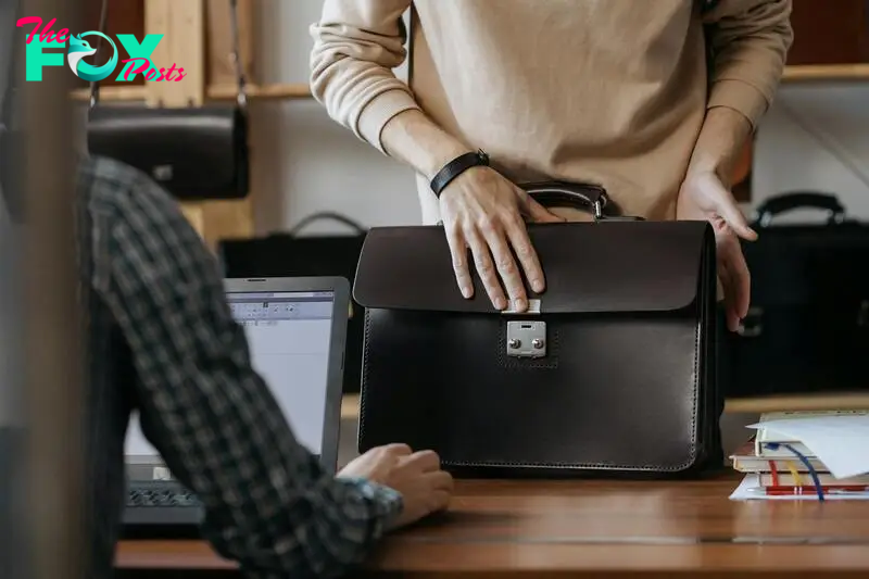 Man placing his black briefcase on the table | Source: Pexels