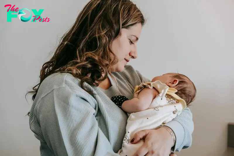 Happy and peaceful mother cuddling with her child | Source: Pexels