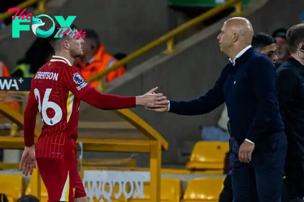 WOLVERHAMPTON, ENGLAND - Saturday, September 28, 2024: Liverpool's Andy Robertson shakes hands with head coach Arne Slot as he is substituted during the FA Premier League match between Wolverhampton Wanderers FC and Liverpool FC at Molineux Stadium. (Photo by David Rawcliffe/Propaganda)