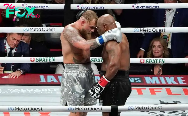 US retired pro-boxer Mike Tyson (R) and US YouTuber/boxer Jake Paul (L) hug after Paul defeated Tyson in their heavyweight boxing bout at The Pavilion at AT&T Stadium in Arlington, Texas, November 15, 2024. (Photo by TIMOTHY A. CLARY / AFP)