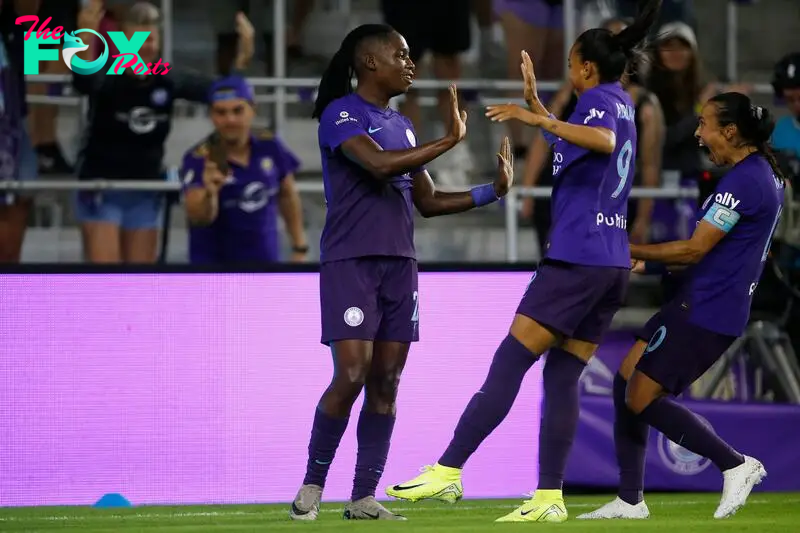 Orlando Pride forward Barbra Banda (22) celebrates with forward Adriana Leal da Silva (9) and forward Marta (10) 