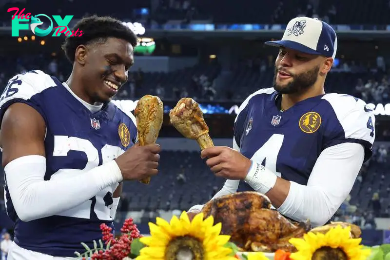 ARLINGTON, TEXAS - NOVEMBER 23: DaRon Bland #26 Dak Prescott #4 of the Dallas Cowboys take a bite out of a turkey leg after a win over the Washington Commanders at AT&T Stadium on November 23, 2023 in Arlington, Texas.   Richard Rodriguez/Getty Images/AFP (Photo by Richard Rodriguez / GETTY IMAGES NORTH AMERICA / Getty Images via AFP)