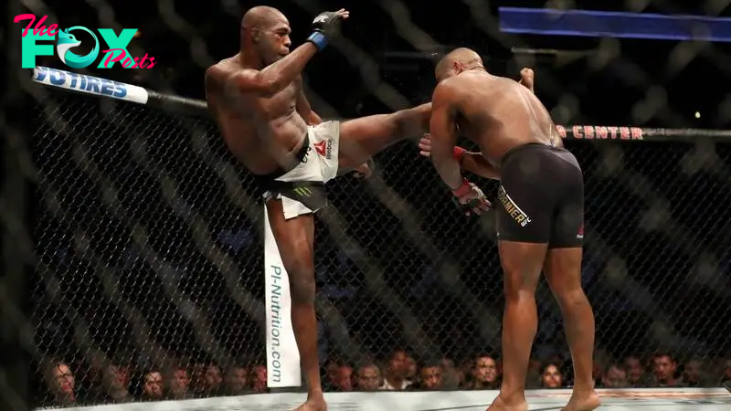 Jon Jones knocks out Daniel Cormier during their UFC 214 bout.