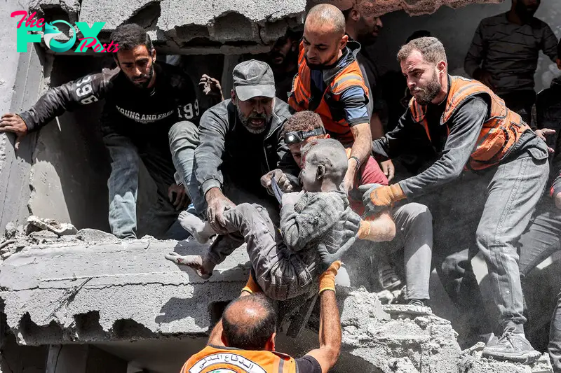 Palestinian civil defense members rescue a child following Israeli bombardment on the Muqat family house in the Zarqa neighbourhood in the north of Gaza City, on Oct. 26, 2024.