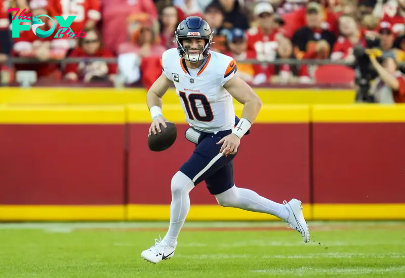 Nov 10, 2024; Kansas City, Missouri, USA; Denver Broncos quarterback Bo Nix (10) rolls out to pass during the second half against the Kansas City Chiefs at GEHA Field at Arrowhead Stadium. Mandatory Credit: Jay Biggerstaff-Imagn Images