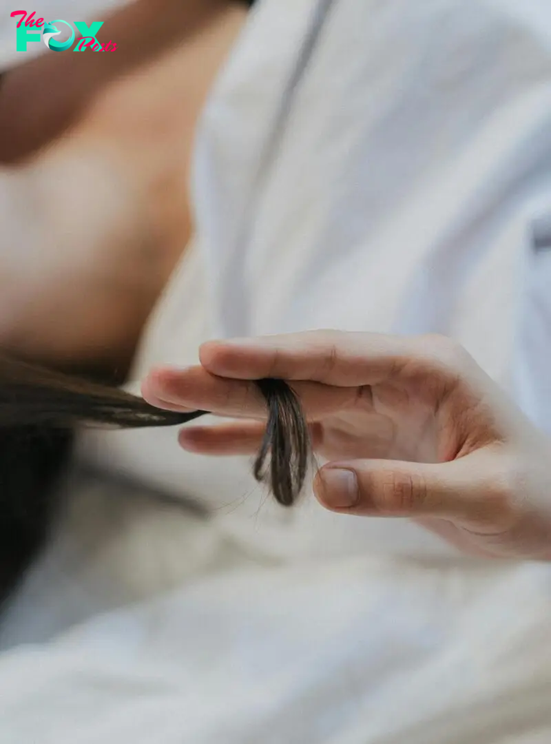 A person twirling a lock of hair | Source: Pexels