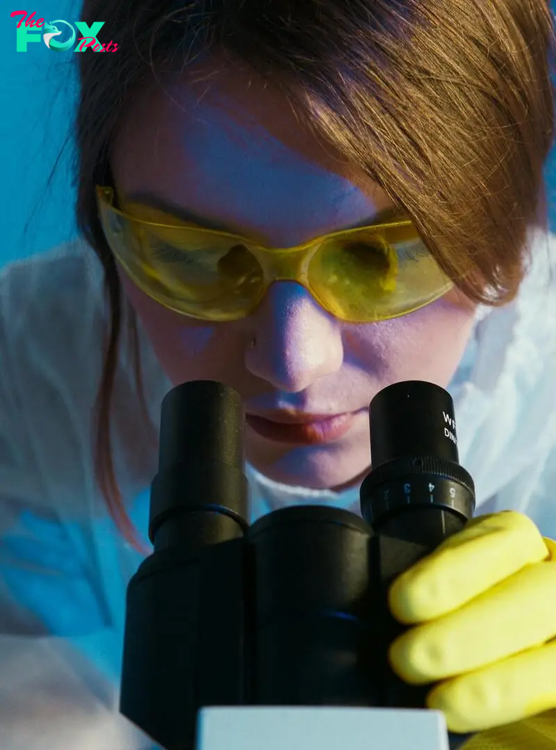 A woman looking through a microscope | Source: Pexels