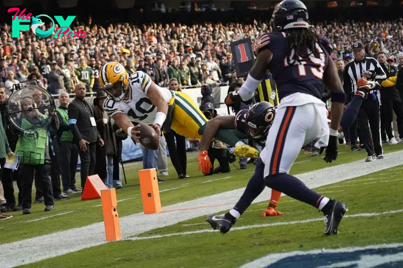 Nov 17, 2024; Chicago, Illinois, USA; Green Bay Packers quarterback Jordan Love (10) dives into the end zone against Chicago Bears safety Kevin Byard III (31) during the second half at Soldier Field. Mandatory Credit: David Banks-Imagn Images