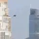 A UFO with a silvery metallic sheen can be seen flying over the center of Mexico City during the day (Video)