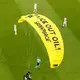 A Greenpeace activist is fined for crash-landing a parachute in stadium before Germany-France match