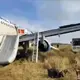 A Russian passenger jet with a hydraulics problem makes a safe emergency landing in an open field