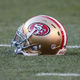 Why do the San Francisco 49ers wear red? What is the origin of their logo?
